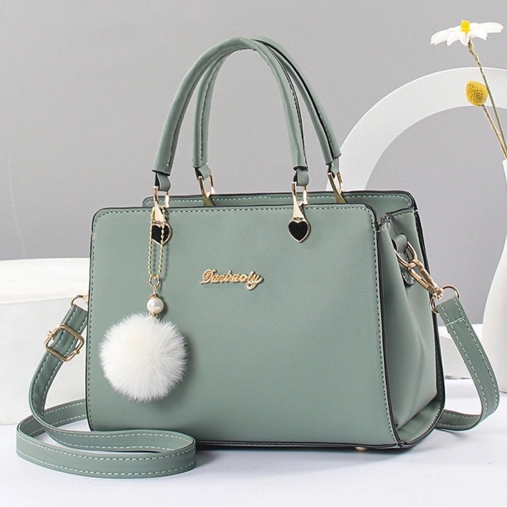 Green Handbag with Pom Pom Charm is very popular and Lu leather